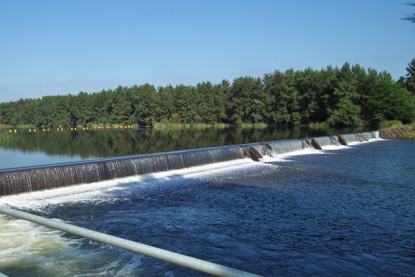 The weir on the Nepean River at Penrith, water stepping over it under a clear sky